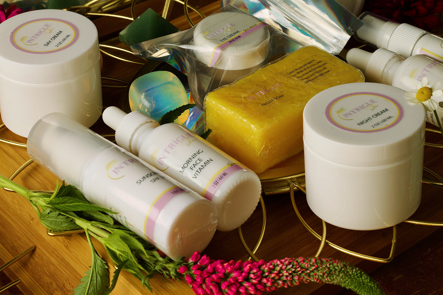 Close up on some Intrigue Skin products surrounded by interesting items.