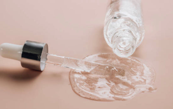 A spilled bottle of salicylic acid and a serum dropper.